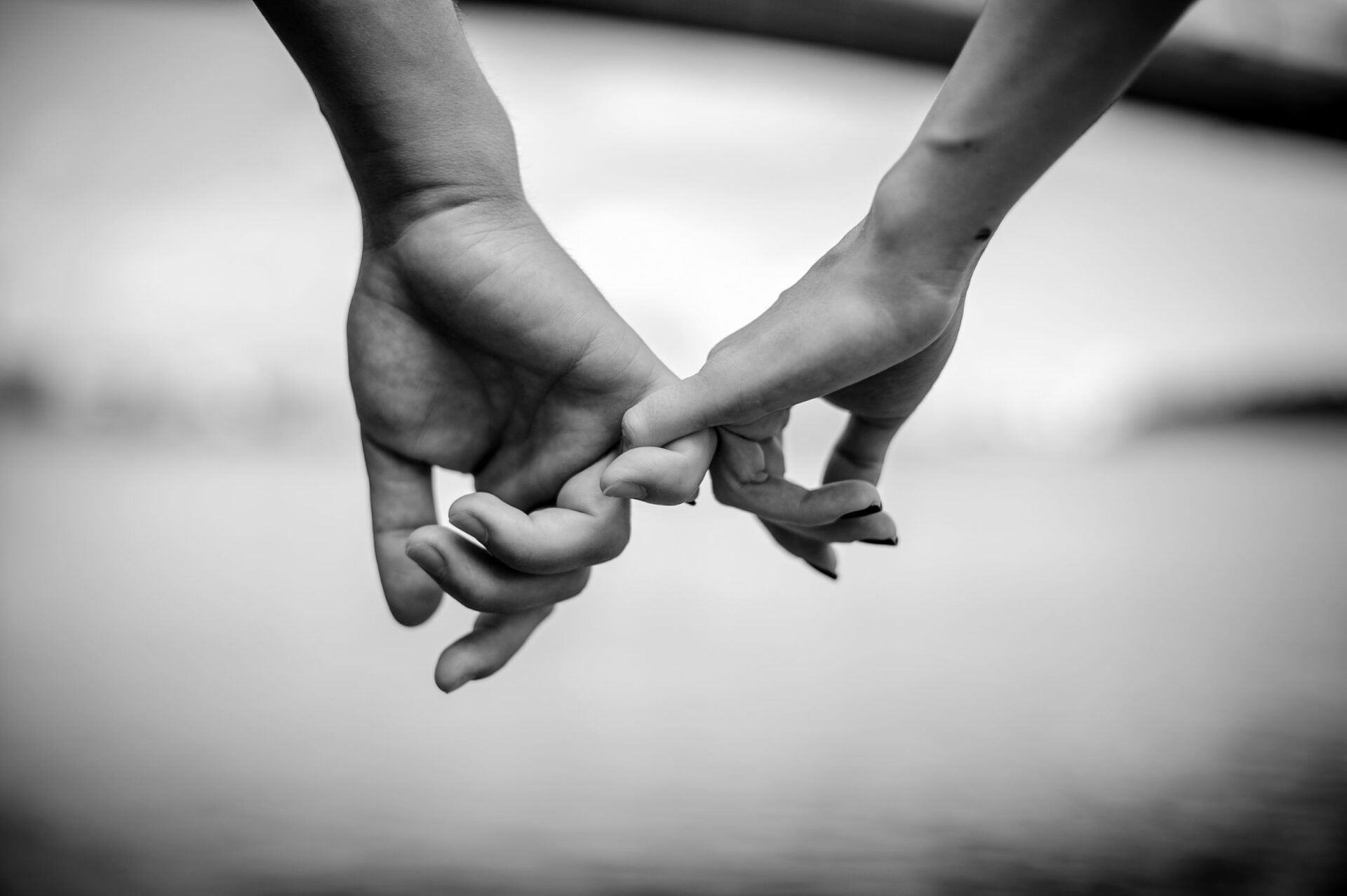 happy couple holding hands black and white